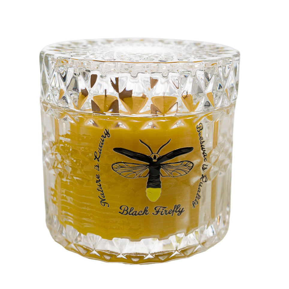 Lavender Lemon Candle in a decorative glass container with a black firefly design on a white background