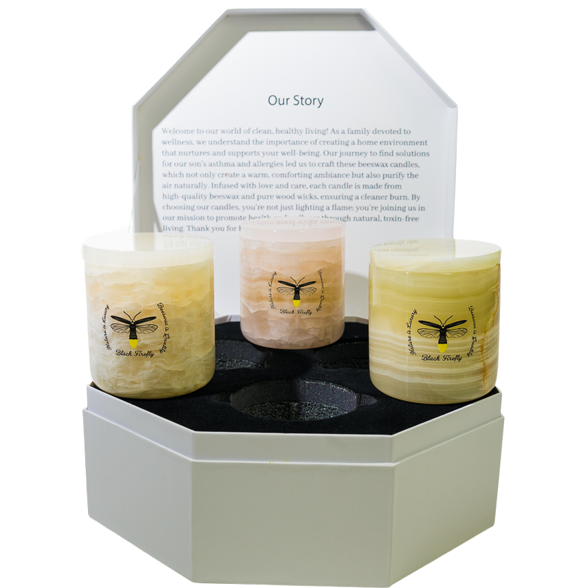 Three candles in a hexagonal holder with a white background