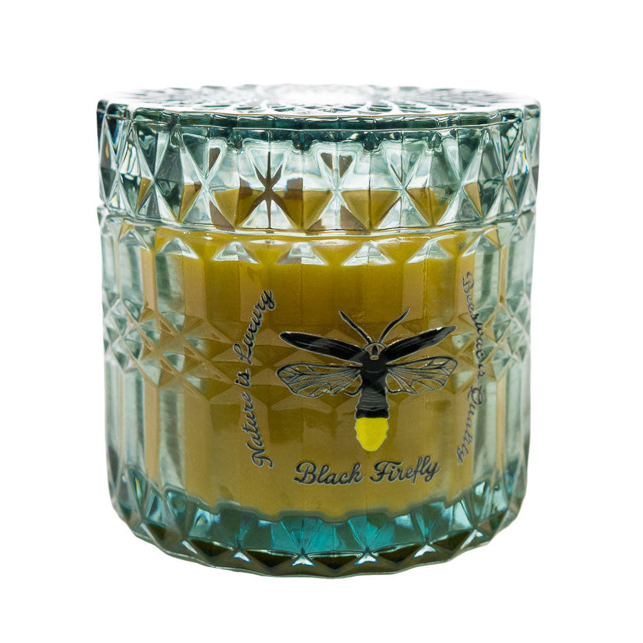 Hills of Mauna Kea - Glass Jar Candle in a textured glass container with a black firefly design on a white background