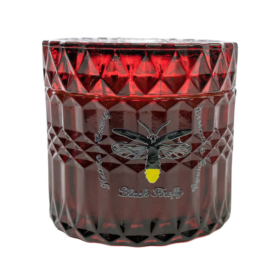 Red Burgundy glass container with a bee design and 'Black Firefly' branding essential oils Himalayan Cedar and Sweet Marjoram