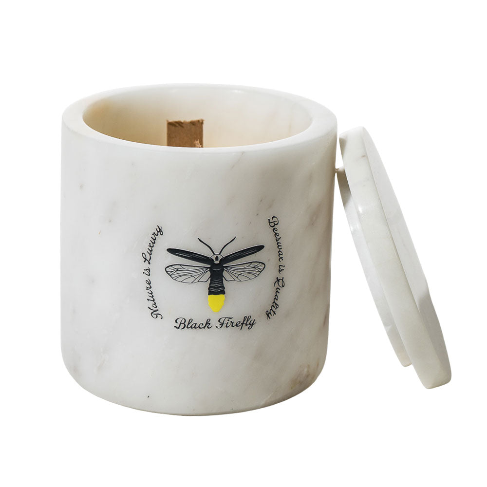 White marble container with black firefly design and text on a white background