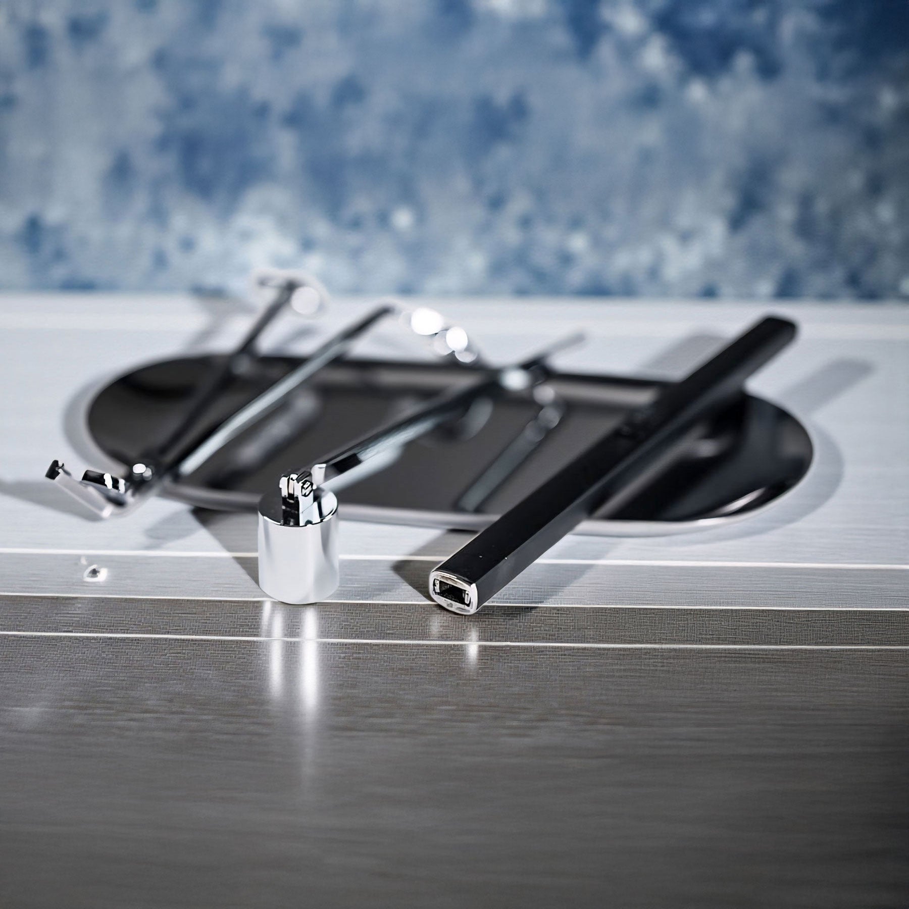 Luxury Candle Care Kit Set of tools including a screwdriver and wrench on a metallic surface with a blurred blue background