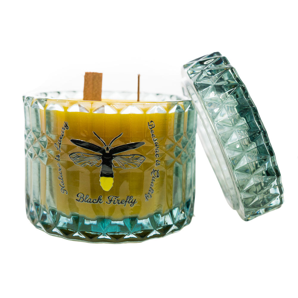 Hills of Mauna Kea - Glass Jar Candle with a decorative lid featuring a black and yellow design on a white background