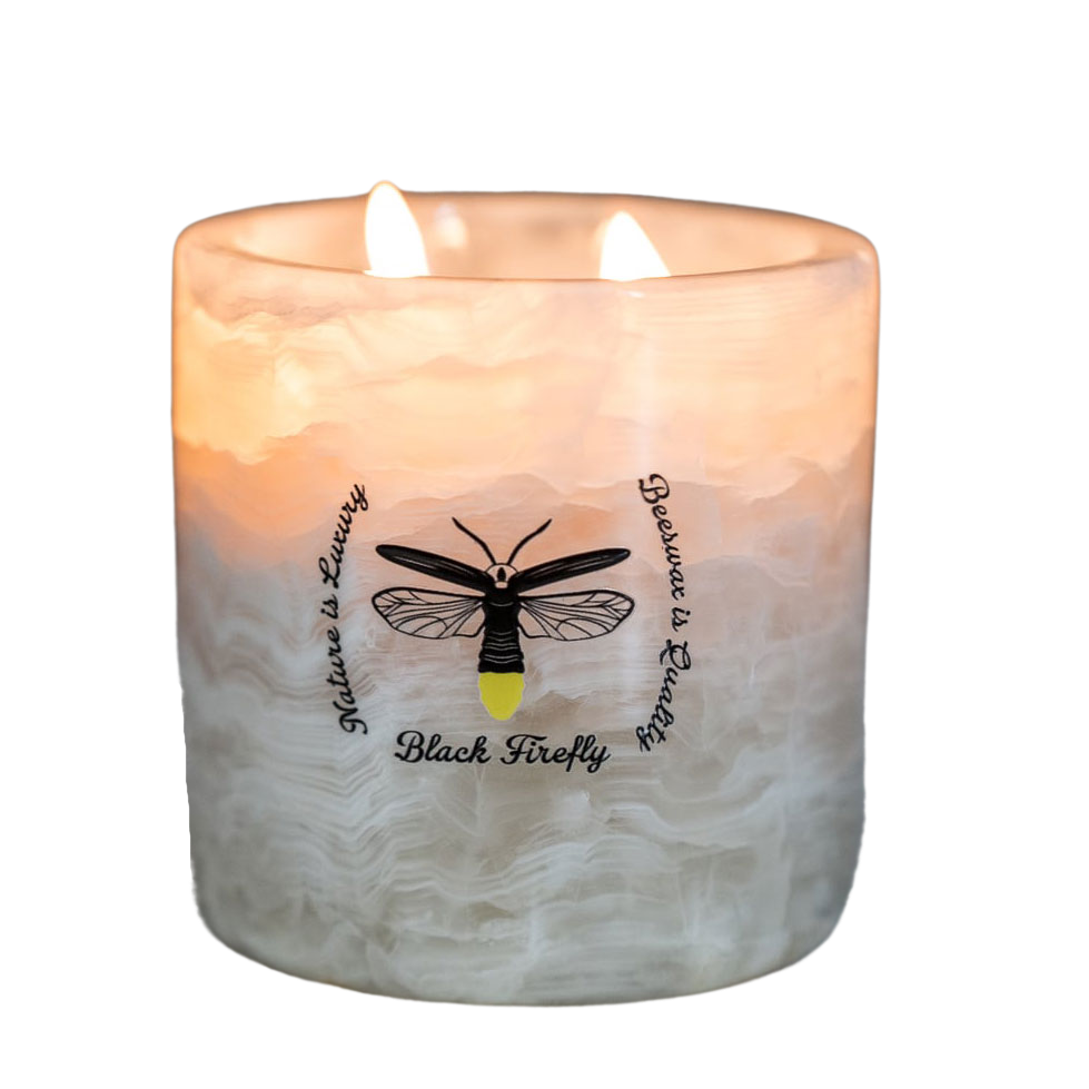 Hills of Galápagos Islands - White Onyx Candle Candle with a black firefly design and text on a white background